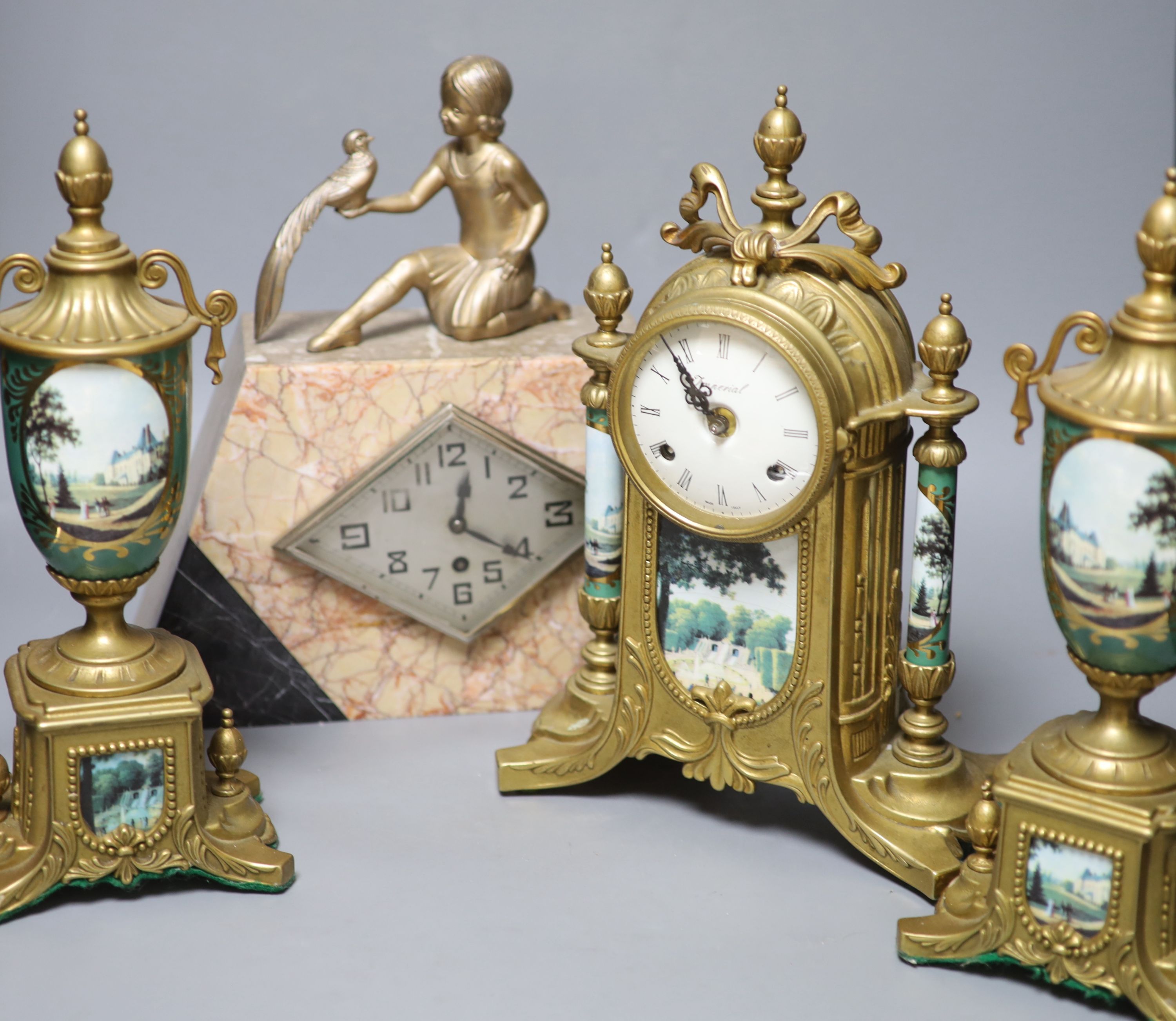 A Louis XV style gilt metal and porcelain three piece clock set and an Art Deco mantel clock, tallest 35cm